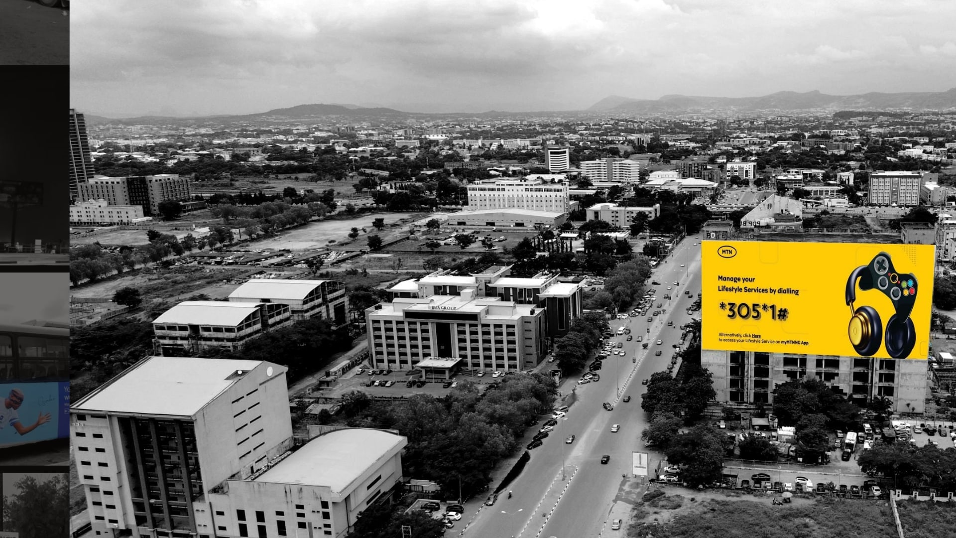 MTN rooftop billboard on the PDP Building beside a dual carriageway in Abuja