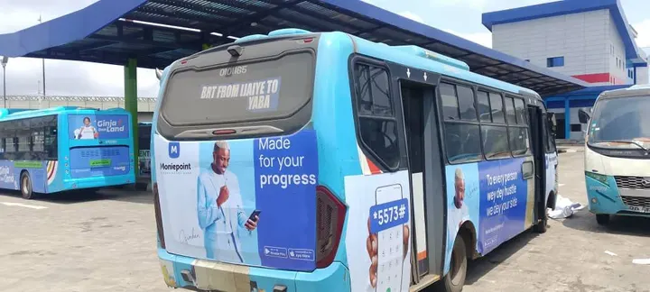 Rear and side wrap on a Lagos BRT bus under the terminal canopy