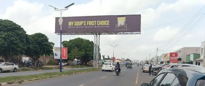 Golden Penny Semovita eyecatcher board over Fate Road, Ilorin, for FMN