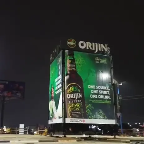 Backlit Orijin tower board at night on a roundabout in Osogbo, Osun