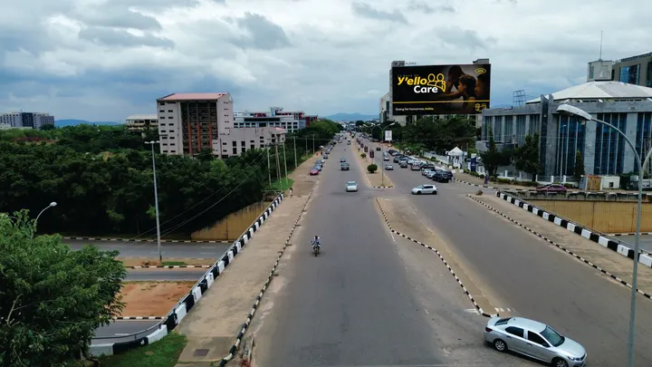 MTN rooftop board above a wide road in Abuja, seen from a drone