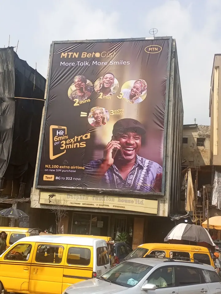 MTN BetaGist wall drape covering a building face above danfos on Idumagbo Avenue, Lagos Island