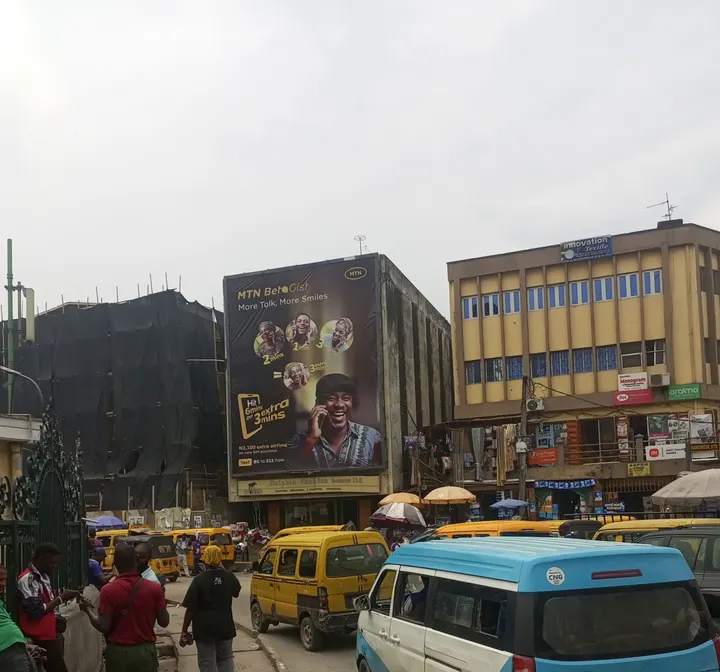MTN BetaGist wall drape above street traffic and pedestrians, Lagos Island