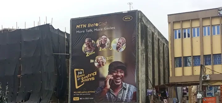 MTN BetaGist wall drape over a busy street at Nnamdi Azikiwe Street and Idumagbo Avenue, Lagos Island